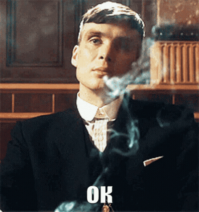 Man In Suit Smoking Cigarette Saying Ok GIF