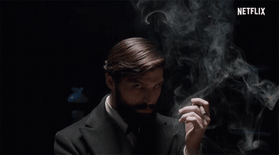 Man In Suit Smoking Cigarette With Netflix Logo GIF