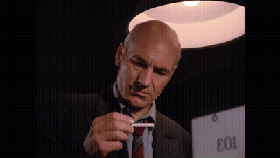 Man In Suit Smoking In Front Of EOI Sign GIF