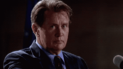 Man In Suit Speaking Into Microphone GIF