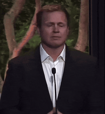 Man In Suit Speaking Into Microphone GIF