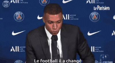 Man In Suit Speaking Into Microphone Le Football Il A Changé GIF