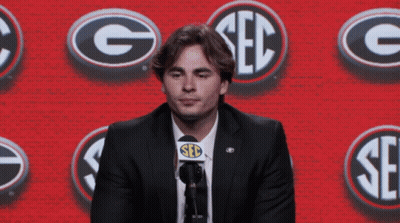 Man In Suit Speaking Into Microphone Saying Seb GIF