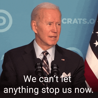 Man In Suit Speaking Into Microphone Saying We Can't Let Anything Stop Us Now GIF