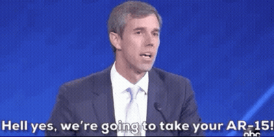 Man in Suit Speaking Into Microphone Says Hell Yes We're Taking Your AR-15