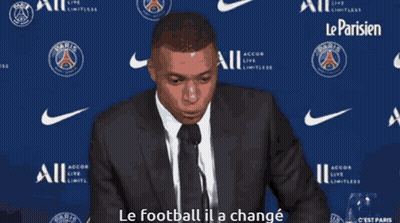 Man In Suit Speaking Into Microphone Says Le Football Il A Changé GIF
