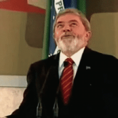 Man In Suit Speaking Into Microphone With PP Flag GIF