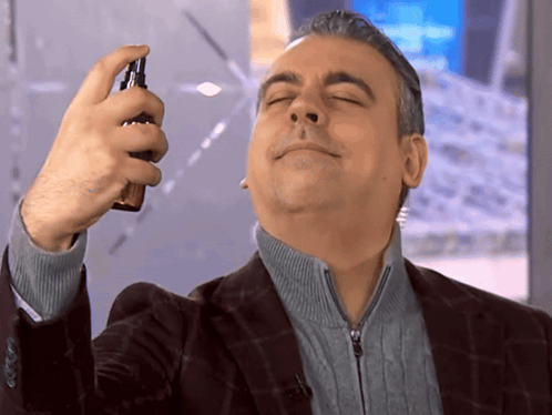 Man In Suit Spraying Face GIF