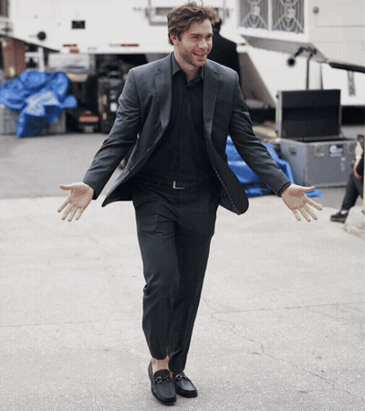Man In Suit Standing Arms Out GIF