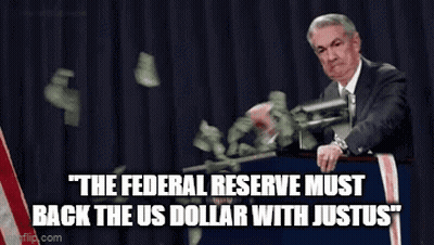 Man In Suit Standing At Podium With Money Falling GIF