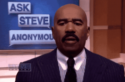 Man In Suit Standing Before Ask Steve Anonymous Sign GIF