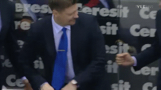 Man In Suit Standing Before Cersit Sign GIF