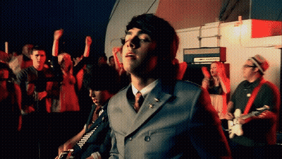 Man In Suit Standing Before Crowd GIF