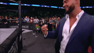 Man In Suit Standing Before Evolve Banner GIF