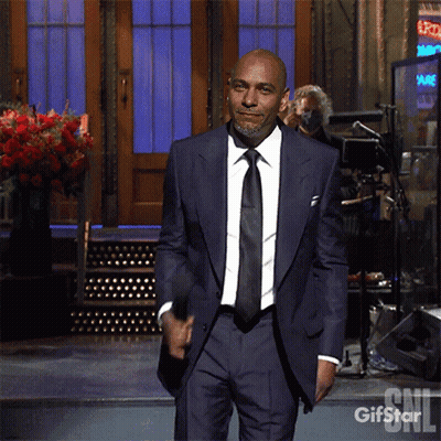Man In Suit Standing Before Gifstar Sign GIF