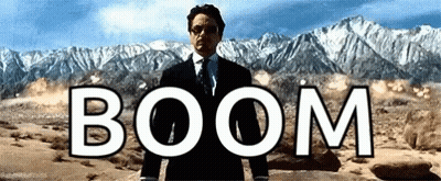 Man In Suit Standing Before Mountain Saying Boom GIF
