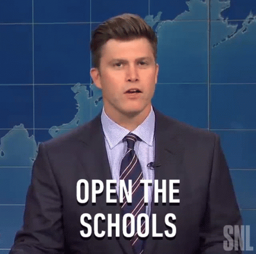 Man In Suit Standing Before Open Schools Sign GIF