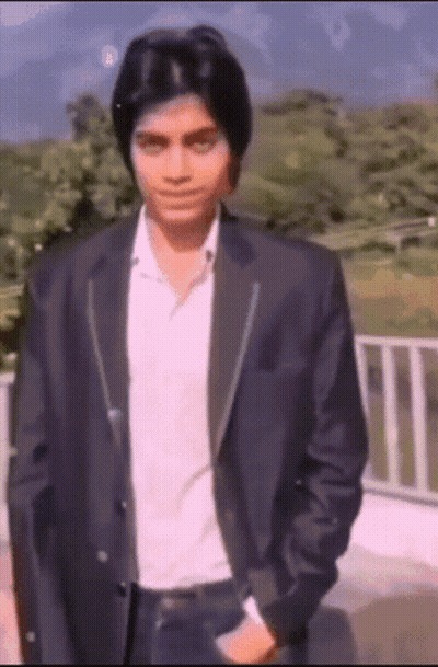 Man In Suit Standing Before Railing GIF