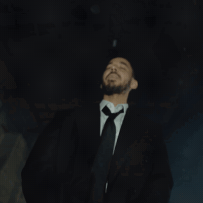 Man In Suit Standing Before Right Sign GIF