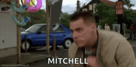 Man In Suit Standing By Blue Car And Donut Shop GIF