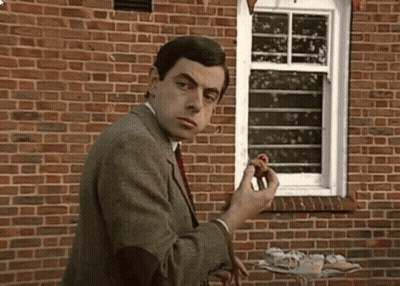 Man In Suit Standing By Brick Wall GIF