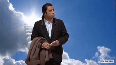 Man In Suit Standing In Blue Sky With Clouds And Kapwing GIF