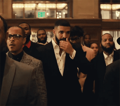 Man In Suit Standing In Crowd GIF