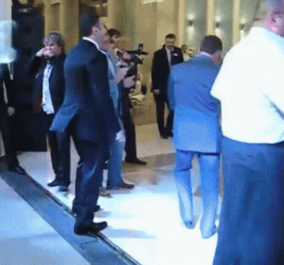 Man In Suit Standing In Crowd GIF