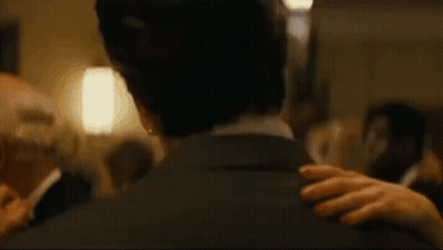 Man In Suit Standing In Dark Hallway With Quote GIF