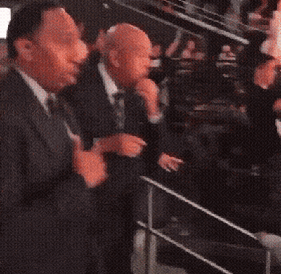 Man In Suit Standing In Dark Room GIF
