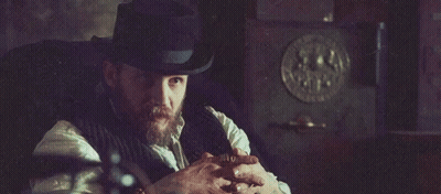 Man In Suit Standing In Dark Room With Hands Outstretched GIF
