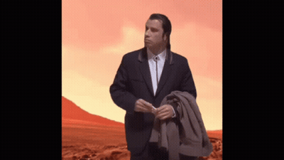 Man In Suit Standing In Desert Holding Jacket GIF