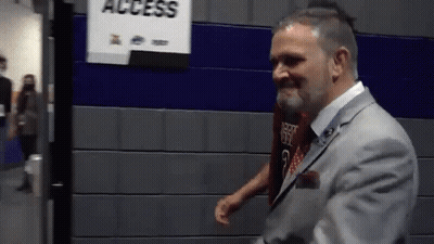 Man In Suit Standing In Front Of Access Sign GIF