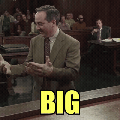 Man In Suit Standing In Front Of Big Sign GIF