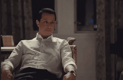Man In Suit Standing In Front Of Blackboard GIF