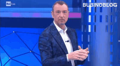 Man In Suit Standing In Front Of Blue Wall Saying Bubinoblog GIF
