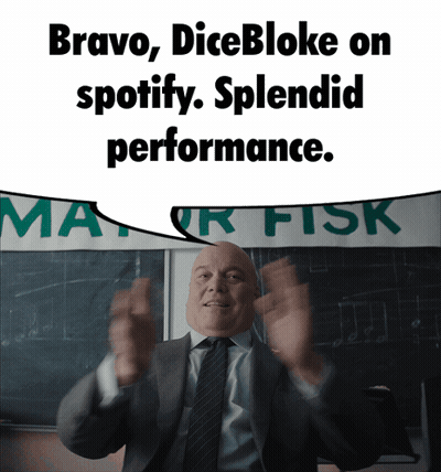 Man In Suit Standing In Front Of Bravo Dicebloke Sign GIF