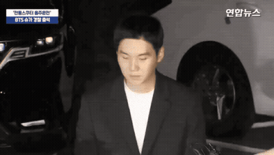 Man In Suit Standing In Front Of BTS Car GIF