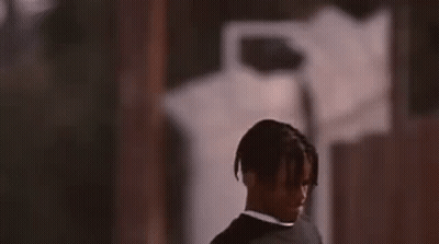 Man In Suit Standing In Front Of Building GIF