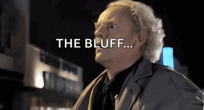 Man In Suit Standing In Front Of Building Saying The Bluff GIF