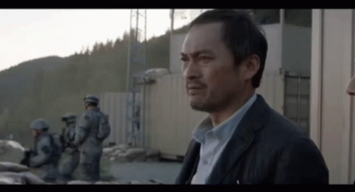 Man In Suit Standing In Front Of Building GIF