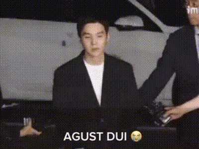 Man In Suit Standing In Front Of Car While Another Man Holds His Hand GIF