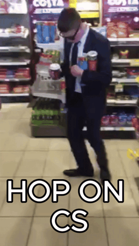 Man In Suit Standing In Front Of Costa Express Fridge GIF