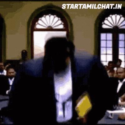 Man In Suit Standing In Front Of Crowd GIF