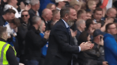 Man In Suit Standing In Front Of Crowd GIF