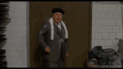 Man In Suit Standing In Front Of Door GIF