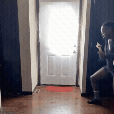 Man In Suit Standing In Front Of Door GIF