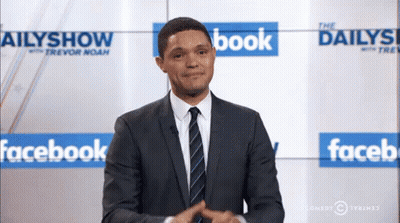 Man In Suit Standing In Front Of Facebook Wall GIF