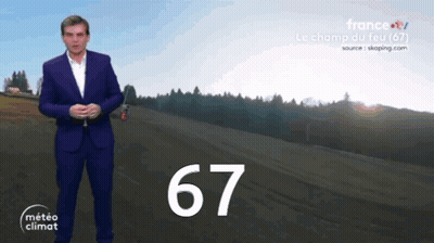 Man In Suit Standing In Front Of Field With Number 67 GIF