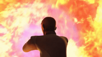 Man In Suit Standing In Front Of Fireball GIF
